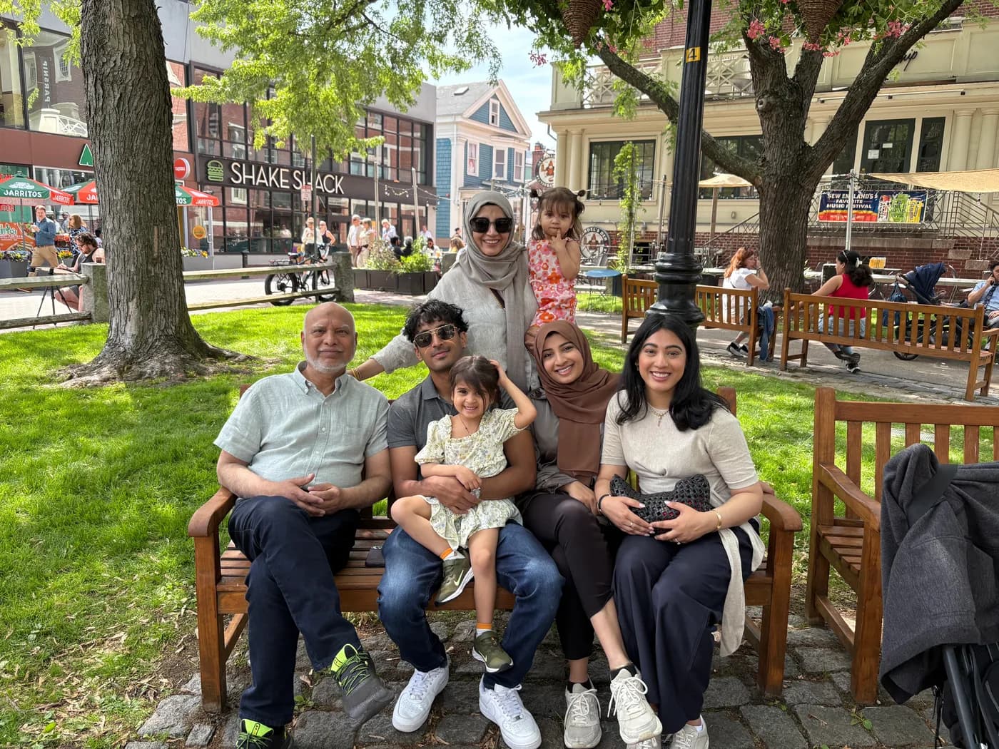 Ali with family on a park bench